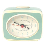 Mint green retro alarm clock with a white snooze button on top.