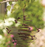 This Double Spiral "Bees" Garden Hanger hands on a tree limb outside the garden. 