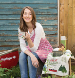 A lady is wearing the classic apron that is red and white patterned with a full front pocket.