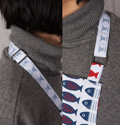 This apron features red and white and blue fish over a white background.