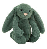 A dark green plush rabbit is in a seated position.