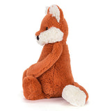 This image of the plush orange fox is shown from the side.