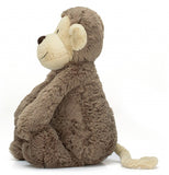The stuffed monkey plush toy is shown from a side profile.