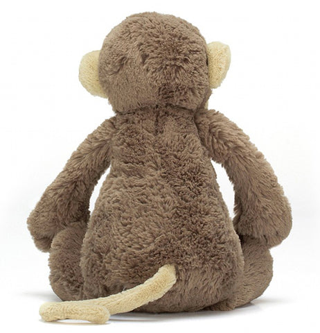 The stuffed monkey plush toy is shown from the back.