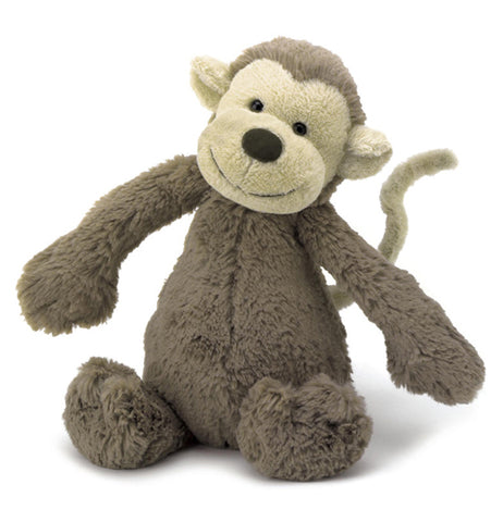 This stuffed plush toy is of a brown monkey with a white tail and a white face with a black nose.