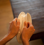 Two hands removing the suction ring from the Baby Bowl.