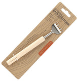 The rake-shaped back scratcher is shown attached to its cardboard packaging with the words, "Extendable Back Scratcher" at the top in black lettering.