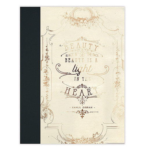 The Clothbound "Beauty is a Light" Notebook features a shimmering gold foil on a durable cover with a message that says, "Beauty is not a face. Beauty is a light in the heart". 