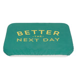 Green polyurethane, cotton, and polyester baking dish cover that says "Better the Next Day" in yellow covering a pan.