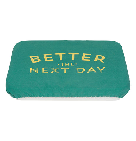 Green polyurethane, cotton, and polyester baking dish cover that says "Better the Next Day" in yellow covering a pan.