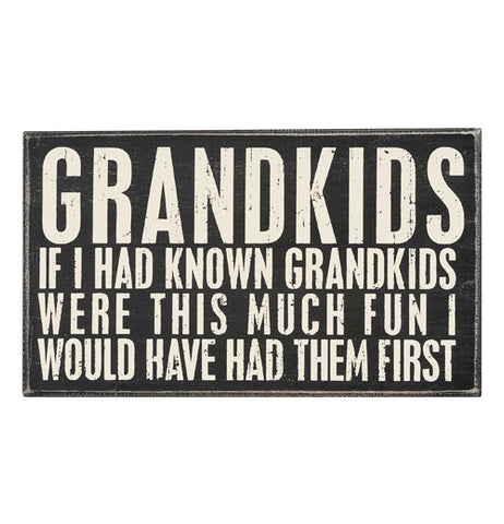 This box sign says "Grandkids If I Had Known Grandkids Were This Much Fun I Would Have Had Them First." The sign is black with white words.