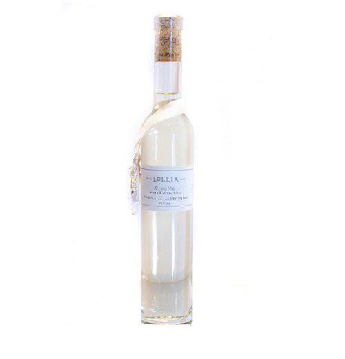 Bubble bath is a tall white bottle with a white ribbon around the bottle says "Lollia Breathe."