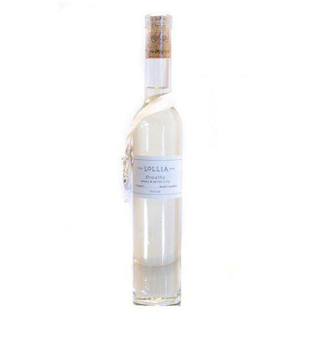 Bubble bath is a tall white bottle with a white ribbon around the bottle says "Lollia Breathe."