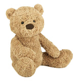 A light brown teddy bear is sitting to the front.