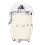 this cream juicer shows its logo SMEG. The top is clear and shows the citrus grinder. There is a spout of the left side.