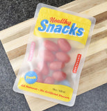 Some cherry tomatoes are shown inside the yellow bannered snack bags.