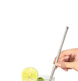 A person's hand is shown putting the silver straw into a drink. 