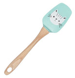 A light blue spatula with a white cat's head on a wooden handle.