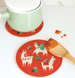this Lalama ceramic trivet with one llama wearing a green scarf, another llama wearing christmas lights and another llama wearing ared scarf with presents.