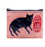 A rose colored coin purse with a black cat saying "I'm not bossy, I'm the boss" in a red speech bubble