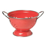 Red colander with silver handles.