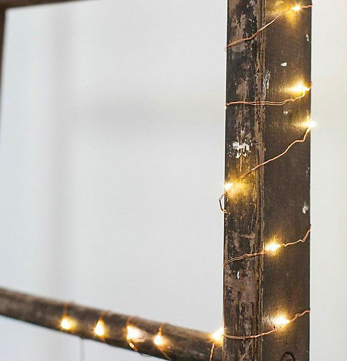 The lights are shown wrapped around a wooden frame.
