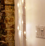 The lights are shown wrapped around a white pillar.