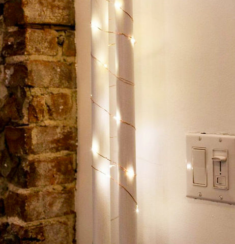 The lights are shown wrapped around a white pillar.