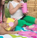 Children drinking one of their "Butterfly" Kids Cups outside.