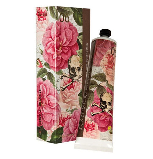 Shea butter lotion with floral flowers illustrated beautifully on it. The lotion is placed next to it&