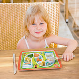 A little girl is shown eating some vegetables from different parts of the board game plate.