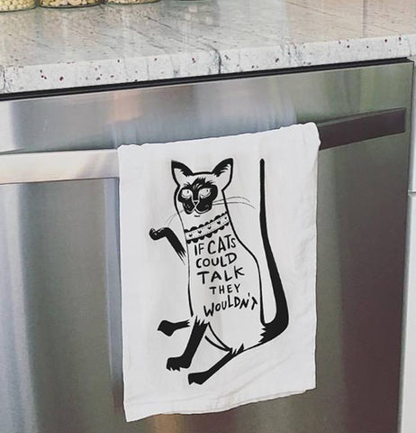 Cat dish towel hanging on the oven door.