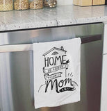 Home is where your mom is dish towel hanging over a oven door.