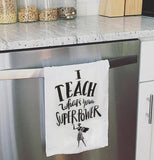 White dish towel hanging on a dishwasher, with a super hero woman at the bottom, that says "I teach what's your superpower."