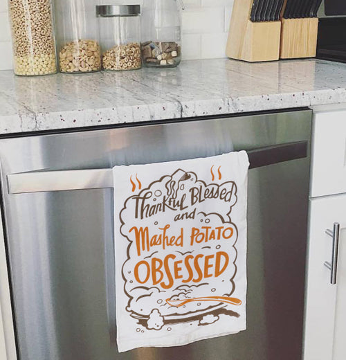 Mashed potato dish towel hanging on an oven door