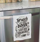 White "Sad Breakfast" that contains black text relating to breakfast hanging over a dishwasher.