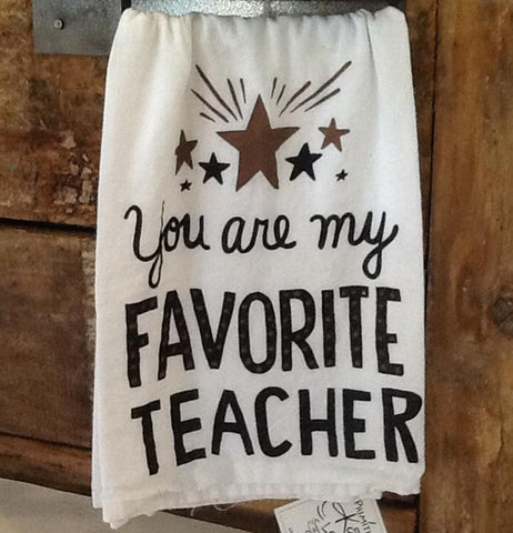 The white towel with the different colored stars and the words, "You are my Favorite Teacher" in white lettering is shown hanging from a drawer.