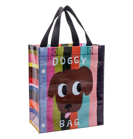 The "Doggy Bag" Handy Tote bag shows a picture of a brown dog's face with his tongue sticking out on a colored striped background