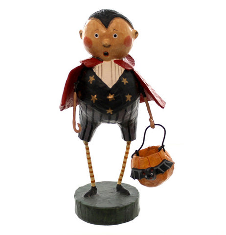 This figurine wears a red cape and a black Dracula costume holding a pumpkin shaped halloween candy bucket with a bat on it.