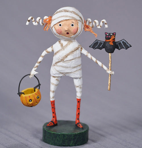 minnie is holding a orange and white candy bucket in one hand and a bat wand in the other.