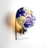 The nightlight shaped to look the earth is shown in use.