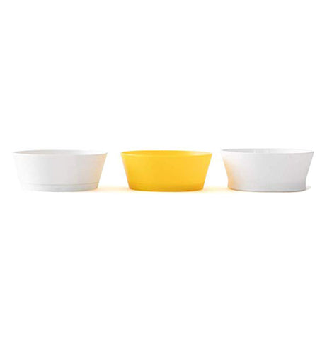 Side view of white and yellow egg slicing tools lined up beside each other on white background.