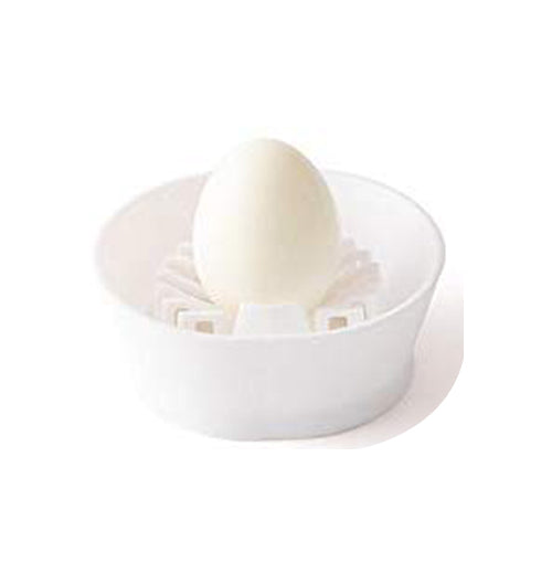 Front view of a hard boiled egg vertically placed in white egg slicer on white background.