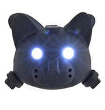 The bike light shaped like a cat's head is shown with its eyes lighting up.
