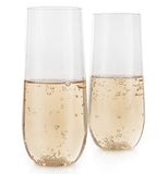 Two stemless champagne flute glasses with liquid in them.