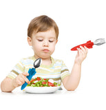 a boy eating a salad using the set of rocket utensils