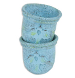 These are small blue planting pots with a bird shape stenciled in their middle.