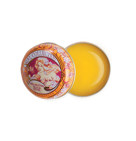 A circular orange and yellow art neaveau tin has orange lip balm in it.