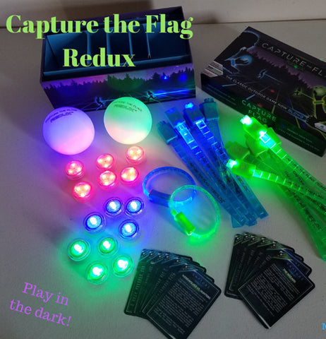 The equipment for the glow-in-the-dark capture-the-flag game is shown lying on a table, and glowing during the night.