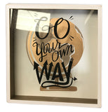 Front view of a shadow box that reads "Go Your Own Way" over a gold, brown, and white globe on a white backdrop.